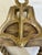 A substantial vintage nautical pulley block featuring a solid wood body encased in a heavy cast metal frame, complete with...