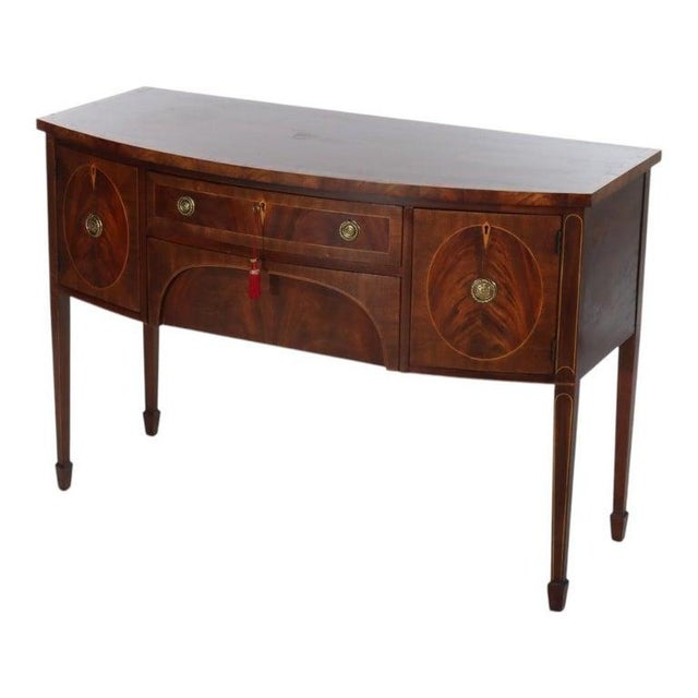 A Henkel-Harris sideboard, retailed by Fallon & Hellen Inc. of Baltimore, presents a distinguished example of English...