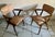 This elegant pair of Mid-Century Modern armchairs was produced in Europe during the 1960s. The chairs feature an...