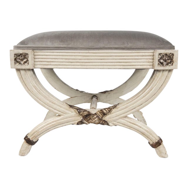 This is a pair of mid-century neo-classical or Gustavian style curule painted ottomans. The mushroom velvet upholstery is...