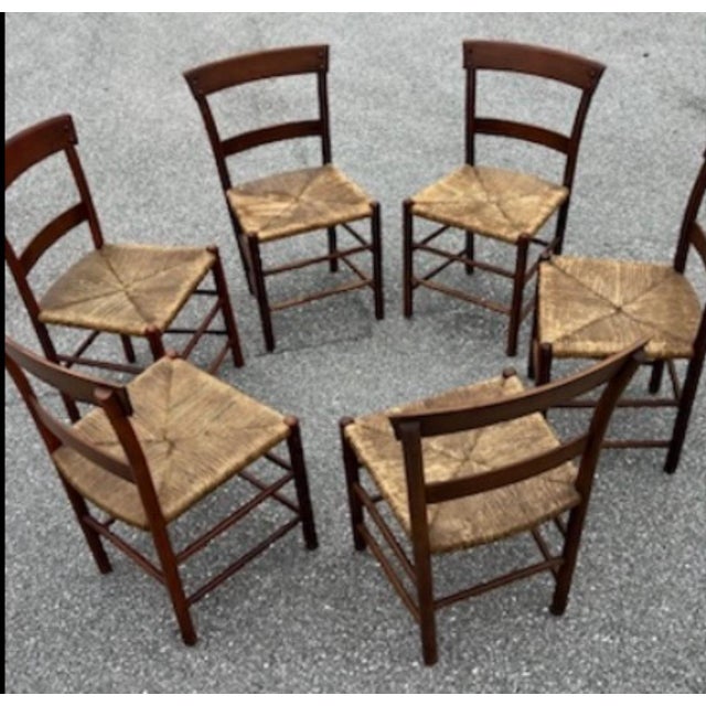 A beautifullyf set of 6 six handcrafted dining chairs, likely of French origin, dating to the mid-20th century. These...
