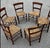 A beautifullyf set of 6 six handcrafted dining chairs, likely of French origin, dating to the mid-20th century. These...