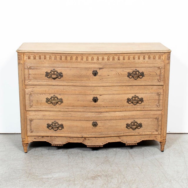 A 19th century French Louis XVI style carved oak commode from Honfleur, the picturesque port town in Normandy known for...