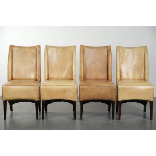 Luxury set of four cowhide leather dining chairs with a beautiful light color, comfortable seat, and high back. : This...