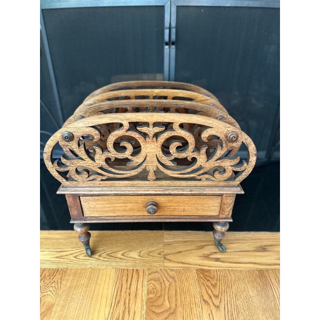 Wooden magazine rack called canterbury sold by Elliston and Cavell retail department store in Oxford, England. Label is...