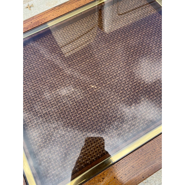 This is a beautiful pair of vintage Bassett end tables with cane tops under slightly smoked glass. Each one features a...