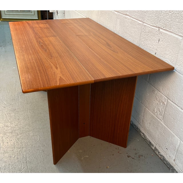 A beautifully crafted mid-century Scandinavian dining table by Nordisk Andels-Eksport of Denmark, showcasing the clean...