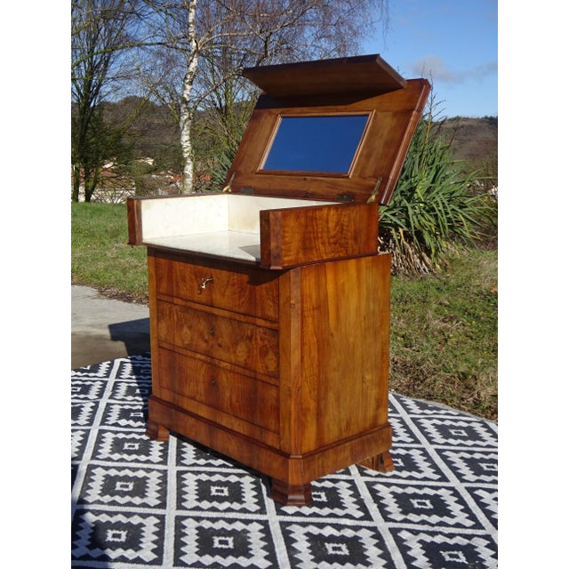 A Louis Philippe style dressing table or vanity unit. Made entirely of solid wood, with walnut burl veneer on the fronts,...