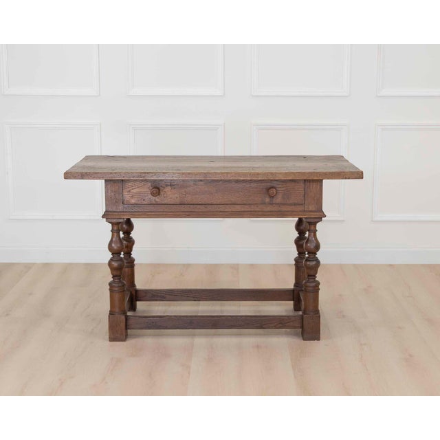 A beautiful 18th century Italian console table crafted from richly aged elm with elegant provincial lines and exceptional...