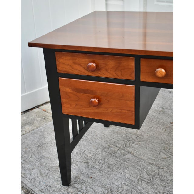 Vintage (1990's) Desk has a Transitional Style. Made by Ethan Allen. Two Tone Finish Black & Cherry. Four Drawers with...