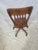 Handsome vintage oak swivel desk chair featuring a classic banker's chair silhouette with a contoured wood seat, six-...