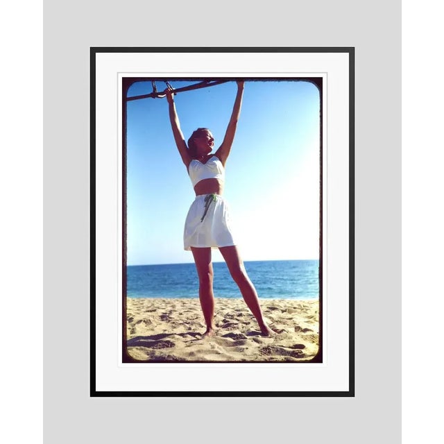 Workout on the beach 1944 a beachwear fashion shoot featuring a model on an exercise bar, usa, 1944. toni frissell...