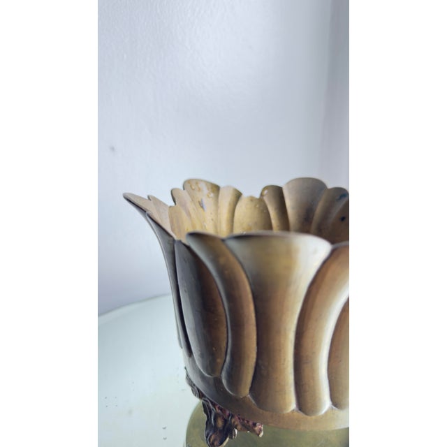 This 1970s brass lotus-shaped gardinere features a scalloped rim and ribbed sides that mimic the petals of a blooming...