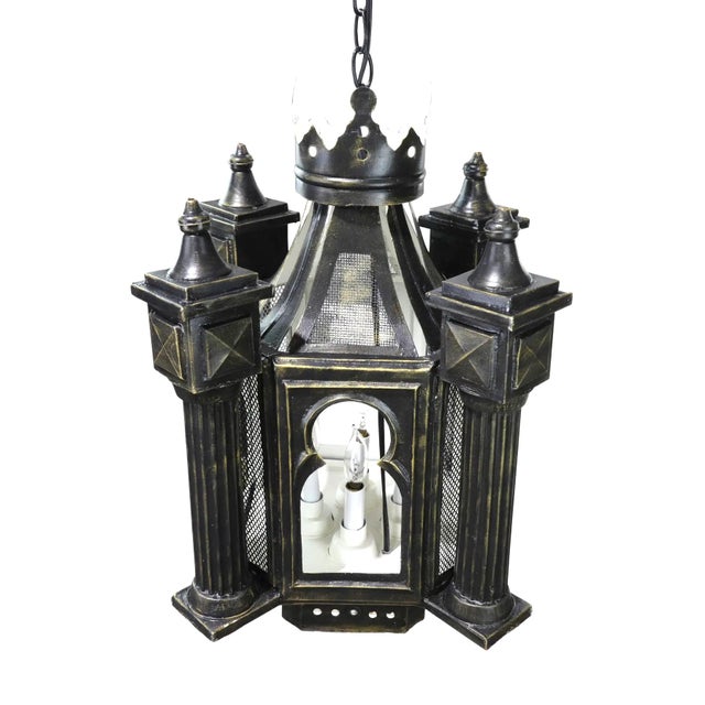 Traditional Tuscan design often features a dark aesthetic, and this exquisite fixture showcases a handmade turret cage,...