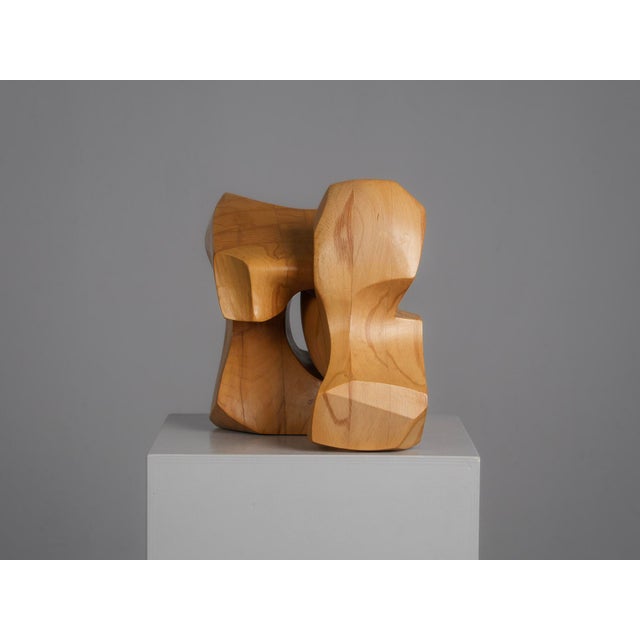 A striking abstract sculpture by dutch artist joop van bergen, hand-carved from solid elm wood. The composition consists...
