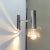 Space Age wall sconce in chrome. A striking detail of this luminaire is the reflector screen that is dissolved in slats....