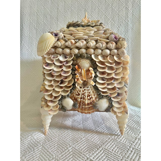 This shell encrusted lidded box has every shell imaginable. It is a large one and stands on 4 spiral shell “legs”. The...