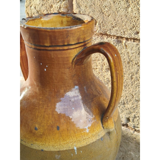Antique glazed terracotta jar with two handles and a beautiful honey-brown finish, a typical rural container from Southern...