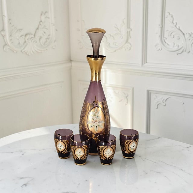 A finely executed vintage Venetian art glass cordial service comprising a hand-blown amethyst glass decanter with its...