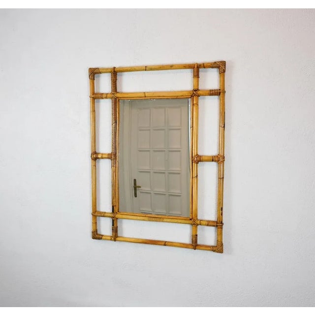 Marvellous wall mirror in bamboo and rattan. This item was produced in Italy during the central part of the 1960s. An...