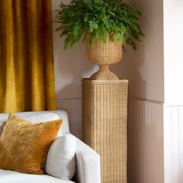 Rattan urns with pedestals holds 5 gallon plant as shown. 13.5" square 61" high. Used for one night; otherwise, brand new...