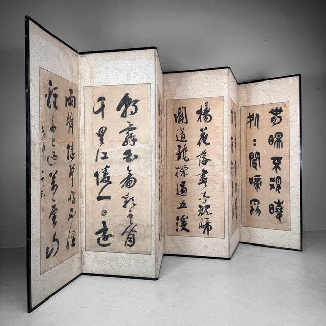 This striking six-panel folding screen is the kind of object that immediately sets the tone of a room: bold ink, softly...