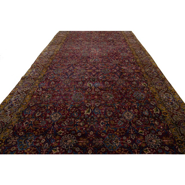 This antique Persian Tabriz rug from the 1880s features a stunning red field decorated with an intricate floral pattern,...
