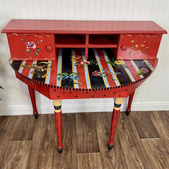 This striking demilune desk (or console) was hand-painted by artist collective Stonehouse Farm Goods for designer Tracy...