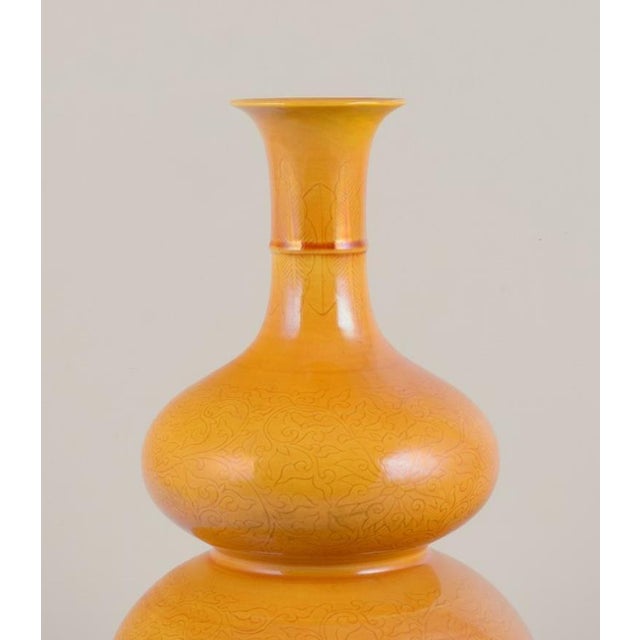 Double gourd-shaped Chinese vase in porcelain. Ochre yellow glaze, classical Chinese floral pattern. from the 19th...
