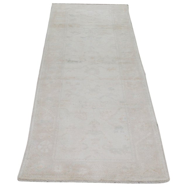 Oushak Hand-knotted with care using traditional rug-making techniques, this wool rug blends timeless craftsmanship with a...