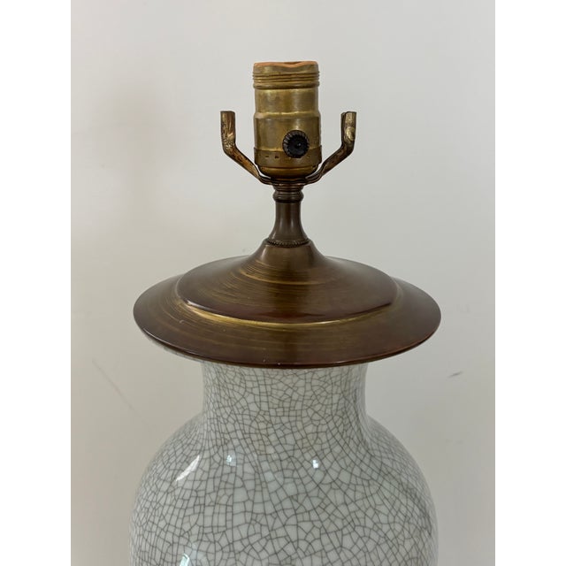 Midcentury light gray vase table lamp with crackle effect and brass cap. Gives off a feeling of elegance and clean...
