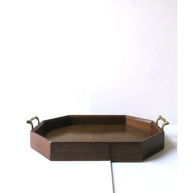 A vintage octagonal wood and brass serving tray, circa 1960s. Tray, octagonal in shape, has a coordinating wood gallery...