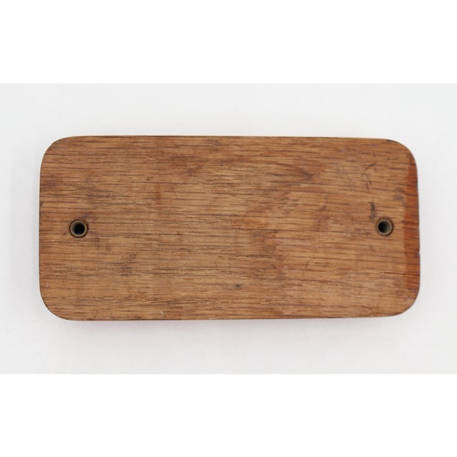 Vintage wood surface mount drawer pull in a rectangular shape with a recessed handle. The original mounting screws are not...