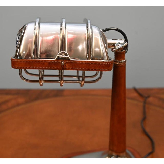Stylish Art Deco style desk lamp Polished chrome finish with tan leather detailing Distinctive ribbed adjustable shade...