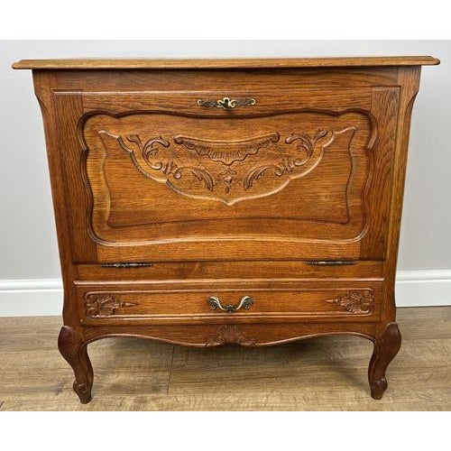A beautifully crafted Vintage French Louis cabinet , featuring elegant carved detailing and a warm oak finish that brings...