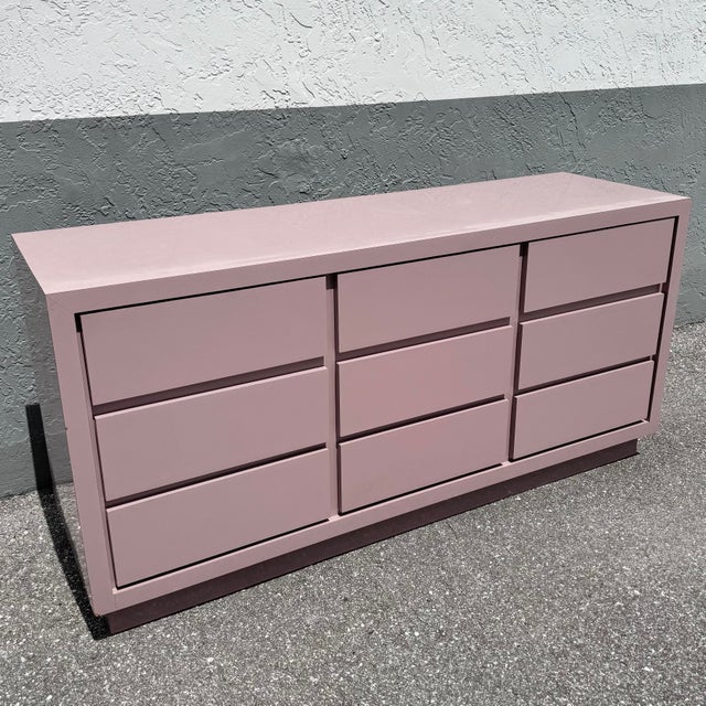 This postmodern dresser makes a striking statement through its bold cubic form and soft mauve gloss finish. Clean...