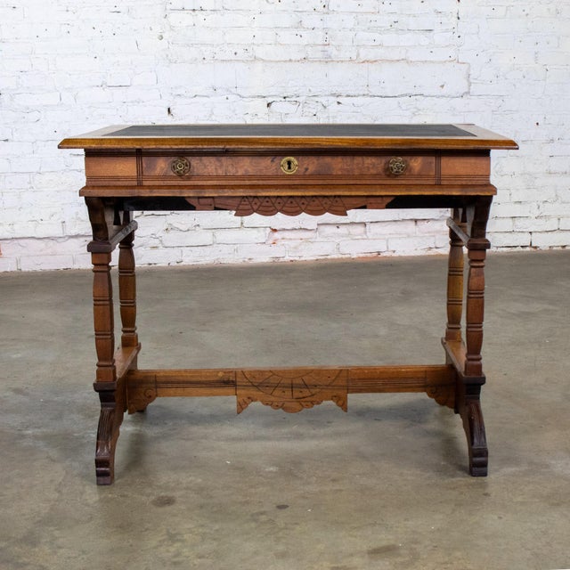 Attractive vintage Eastlake Victorian style ladies writing desk composed of a walnut frame with carved burlwood panels,...