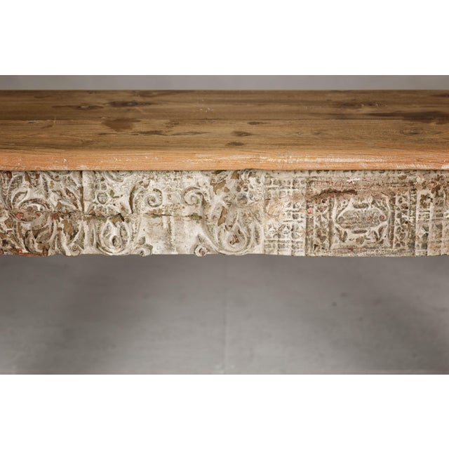 A Mughal style whitewash console table with carved apron and legs. This Mughal style whitewash console table, with its...