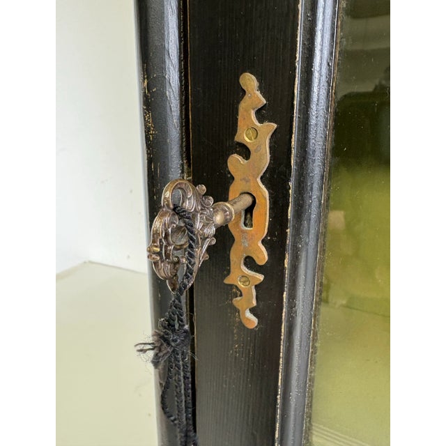 This is a mid-century vintage handcrafted wall cabinet by Chapman. This hand painted cabinet has a black background with a...