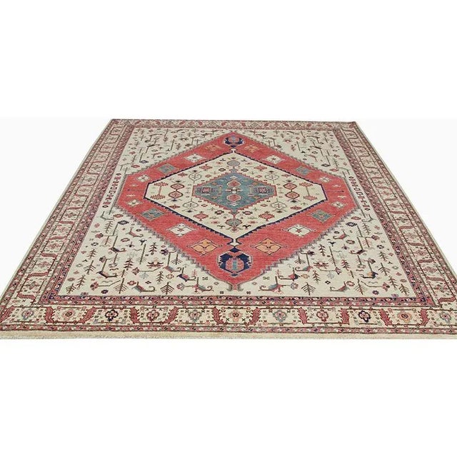 Traditional Handwoven Serapi Style Area Rug featuring a medallion and corners design in a red-colored field enclosed in a...