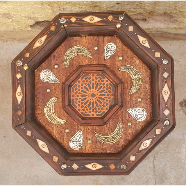 Very exotic octagonal metal inlaid Moroccan side table. With its detailed carving along the sides and the top, this side...