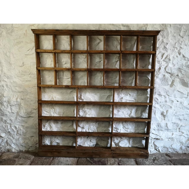An industrial Spanish pine wall or free standing shelf with various size pigeon hole shelves. Made of solid pine it has a...
