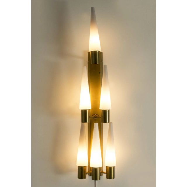 Amazing wall chandelier by Hans-Agne Jakobsson, made in brass with opaline glass shades. Slender, tapering shades in a...
