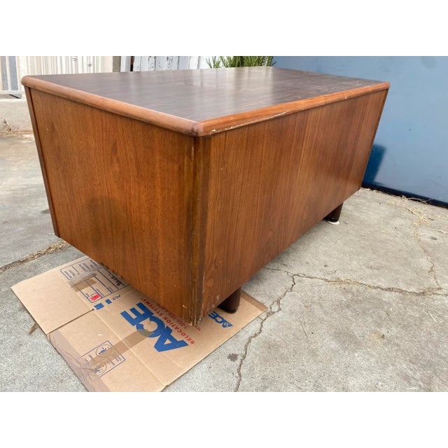 Vintage mid century modern wooden desk with typewriter shelf needs restoration and door is a little bent , works fine...