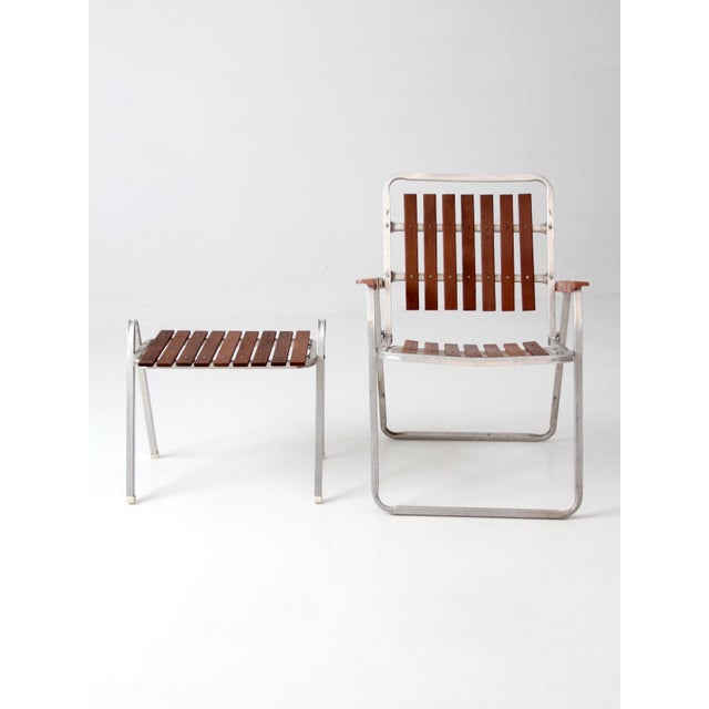 Vintage mid-century folding patio chair and side table set showcasing the playful modernist design and practical elegance...