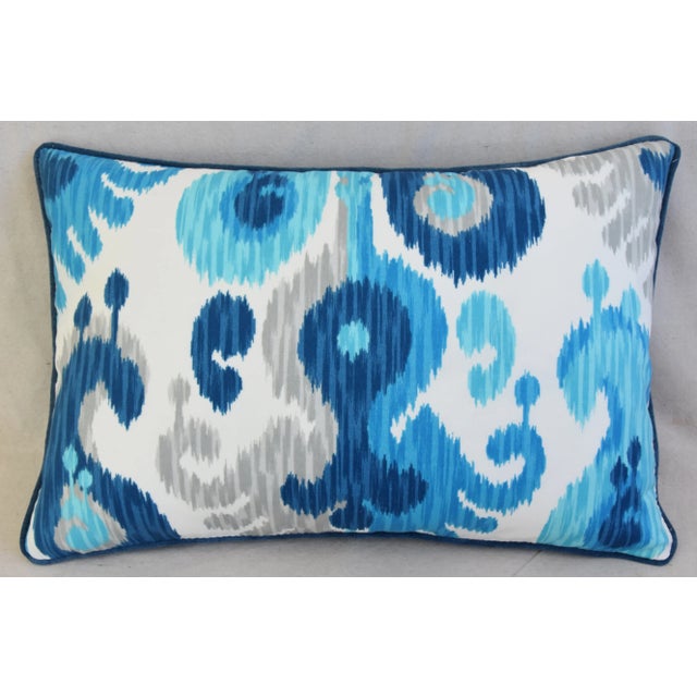 Custom-tailored pillow in a linen-blend ikat print fabric in blue, white, aqua, and gray. Blue cotton velvet fabric back...