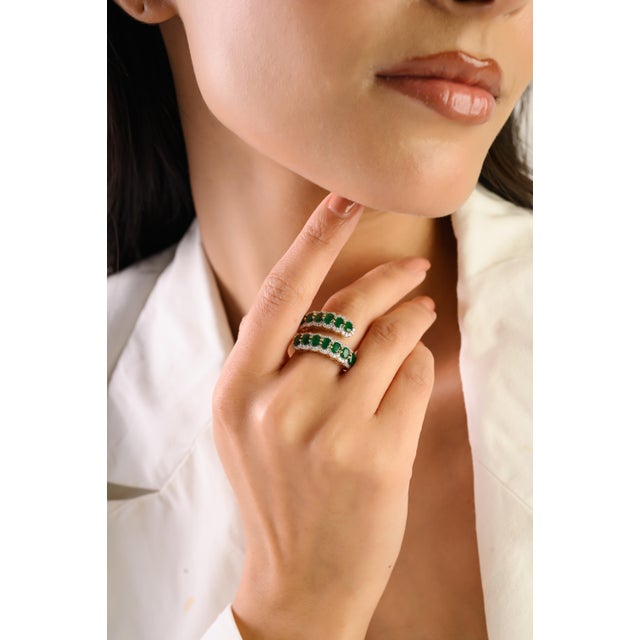 This statement wrap ring showcases 14 vivid oval-cut Zambian emeralds totaling 1.92 carats, set in rich 14k yellow gold....