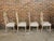 A set of four English Gothic Revival bleached oak dining room chairs with broken arch backs, faceted tapering legs and...