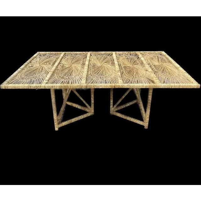 Fantastic vintage iconic sunburst dining table made of rattan & wicker. Beautiful wrapped truss design pedestal. Circa...