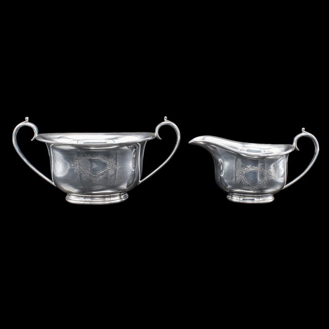 This is an antique sugar dish and creamer duo. An English, silver plated coffee service set, dating to the early 20th...